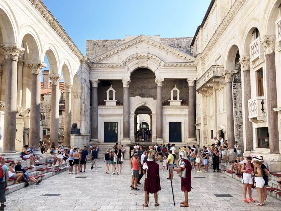 Roman Soliders and tourist standing in the Peristyle of Diocletians Palace, Split