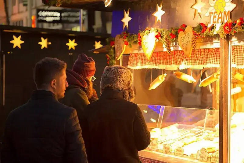 Group tour looking at a stall in a Vienna Christmas market