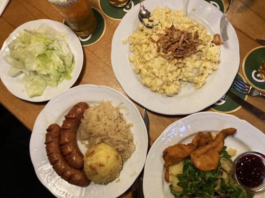spaetzle, bratwurst, schnitzel and more at a traditional tavern meal in Vienna Austria