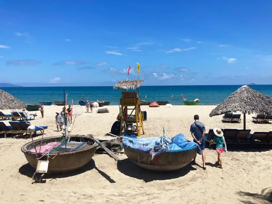 Lifeguard Stand and basket boats on the sand in front of blue waters at An Bang Beach