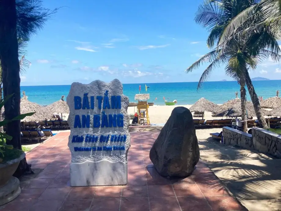 Stone with beach name at the entrance to An Bang Beach Hoi An Vietnam