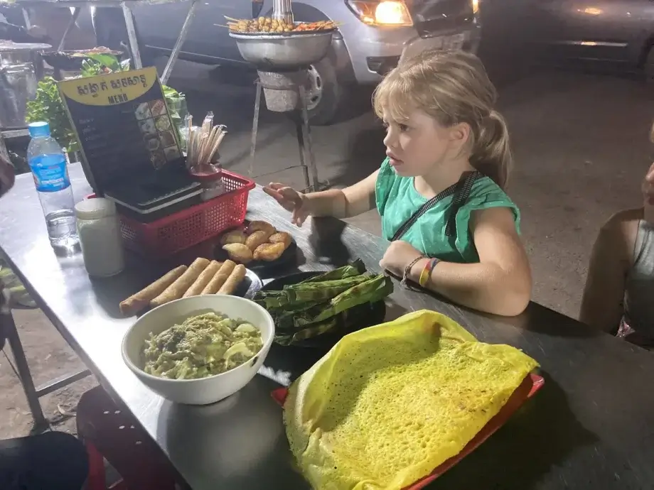 E waiting to start digging into all the Khmer food in front of her on our Siem Reap Food Tour