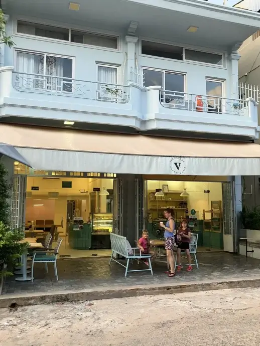 Outside of the Village Bakery with awning and our family out front